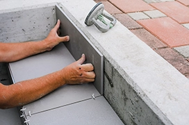 The Grounds Guys service professional installing concrete steps.