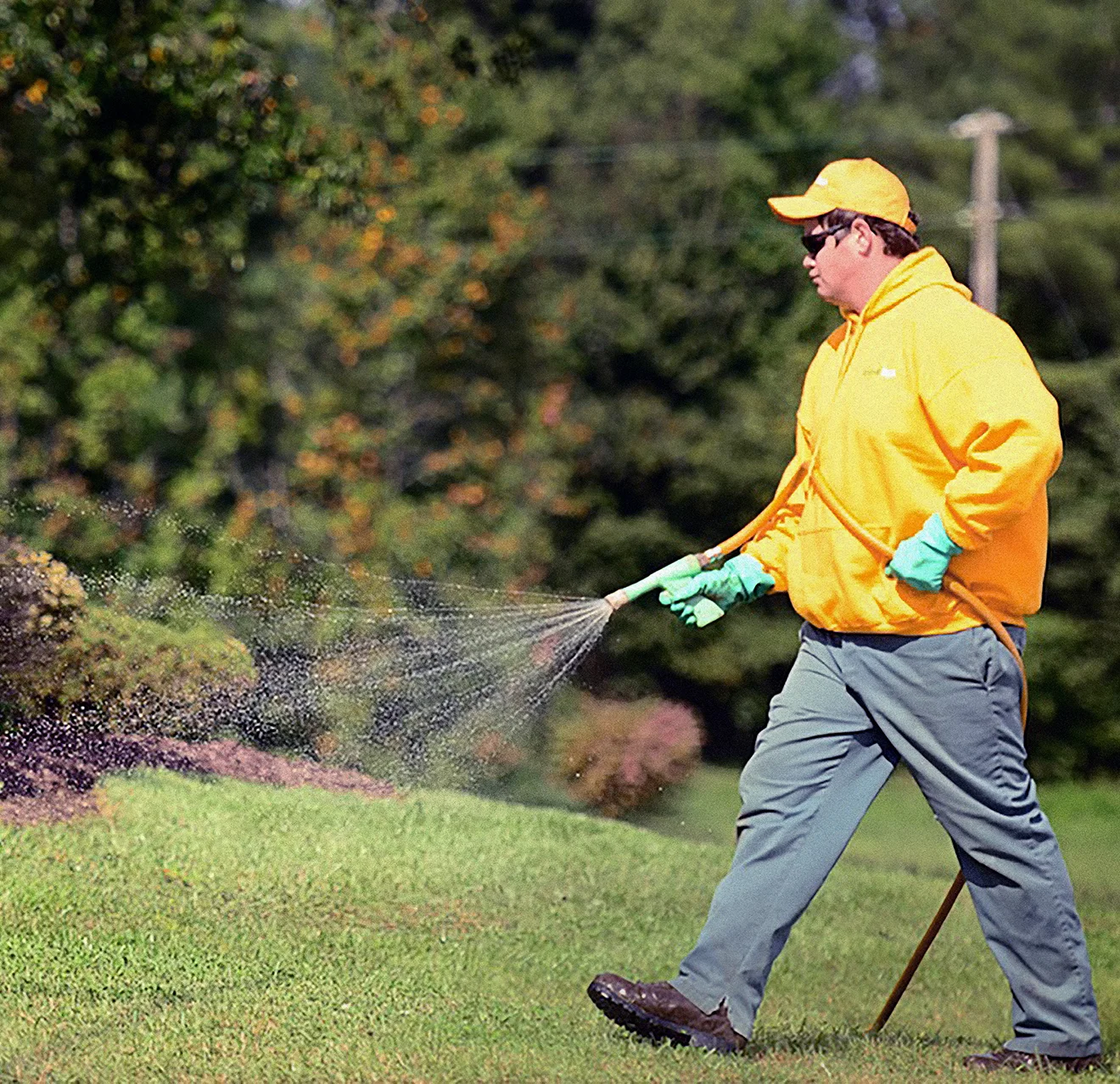 Guy employee spraying pest control.