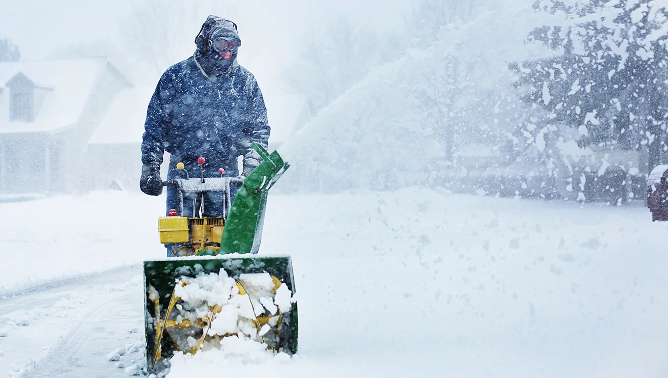 GUY technician blowing snow.