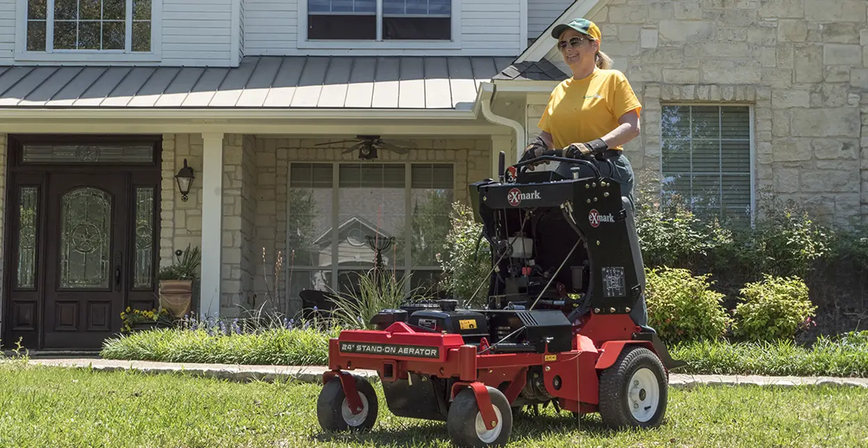 GUY technician mowing lawn.