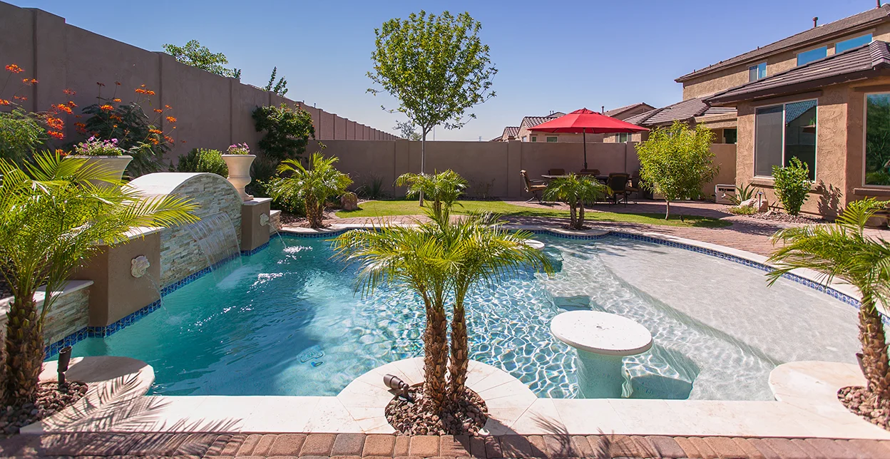 A beautiful residential pool with lush landscaping.