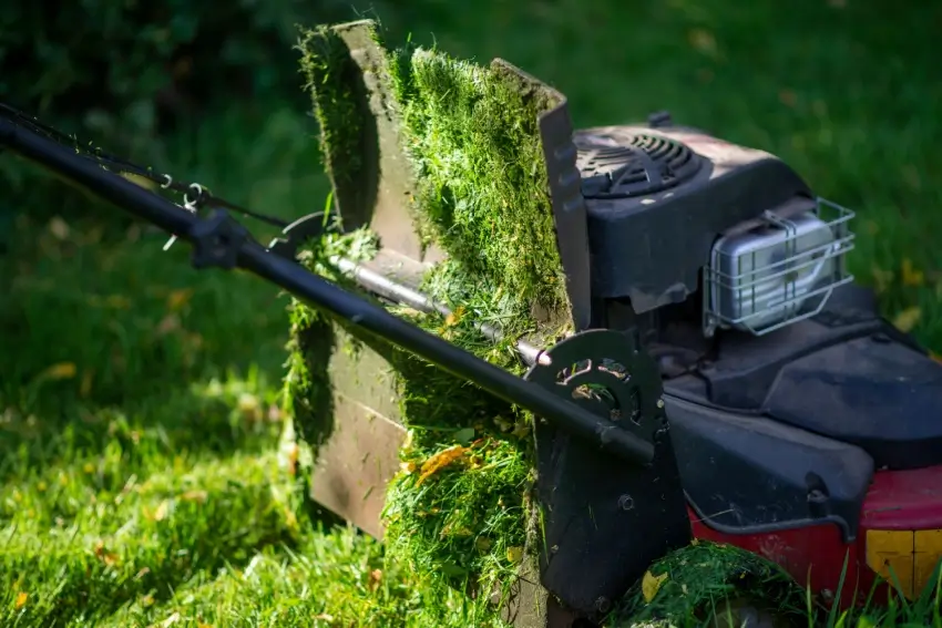 Clogged lawn mower from cutting wet grass.