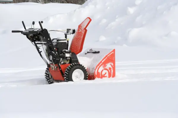 Snow blower on top of snow.