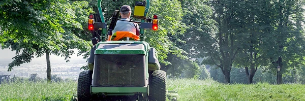 Man driving a riding lawn mower