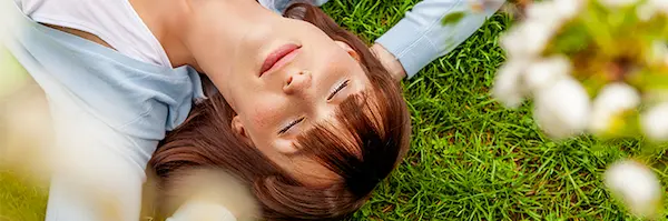 Woman resting on a lawn.