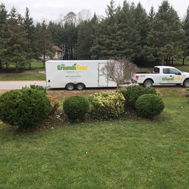 The Grounds Guys with their equipment vehicle